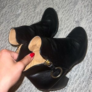 Black ankle booties with gold loop zipper